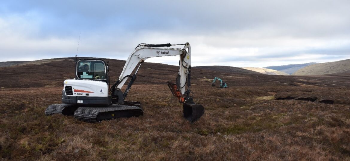 Excavator undertaking peatland restoration