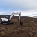 Excavator undertaking peatland restoration
