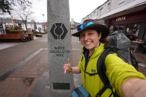 Selfie of walker in yellow jacket at start of West Highland Way