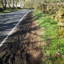 Muddy footway along side of road