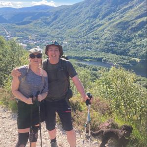 2 hikers with hills behind