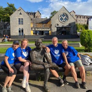 4 people with statue at end of West Highland Way