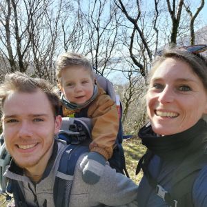 Woman and man with baby in carrier on back