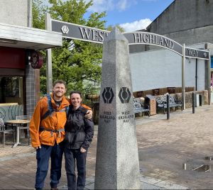 Two people at start of West Highland Way stone obelisk